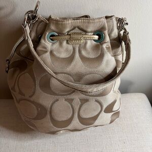 Beige Coach Poppy Signature Lurex drawstring bucket shoulder bag